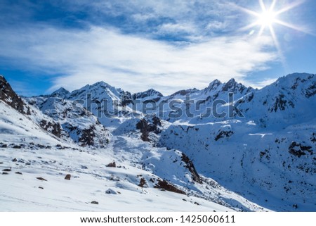Snow covered mountains in the Talkeetna Mountain Range of Alaska. Snow is melting under a bright spring sun in April near Hatcher Pass Recreation Area