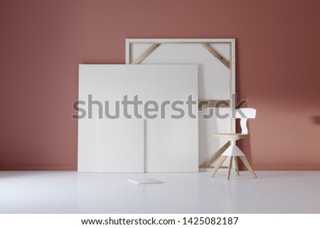 Pictures and chair in red studio with atmospheric lighting