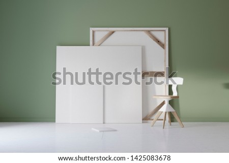 Pictures and chair in green studio with atmospheric lighting