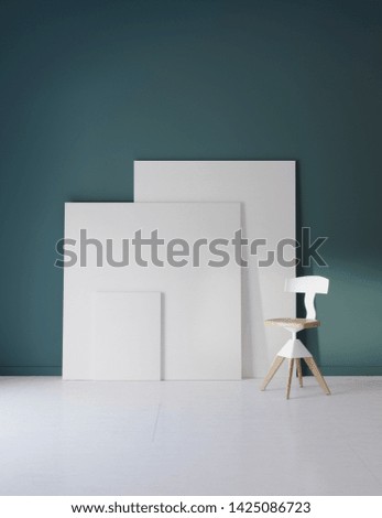Pictures and chair in blue studio with atmospheric lighting