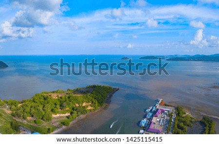 Aerial view of natural forest trees with sand, tropical beach and waves rolling into the shore, Andaman sea, Phuket bay island in summer season, Thailand. Top view