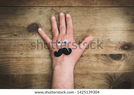 Men's hand with a funny face