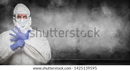 Man Wearing Hazmat Suit and Goggles In Smokey Room Banner with Copy Space. Royalty-Free Stock Photo #1425139595