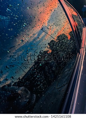 Water drops on car’s windows at the sunset