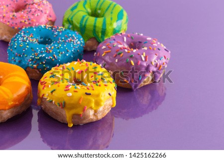 A Batch of Rainbow Colored Glazed Donuts