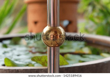 Close-up picture of golden stainless steel stair railing on the balcony of the house