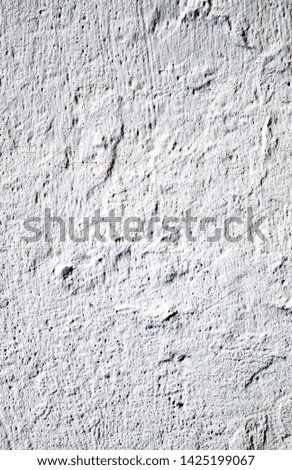 White wall of concrete, cracked grunge wall background. Vertical photo.
