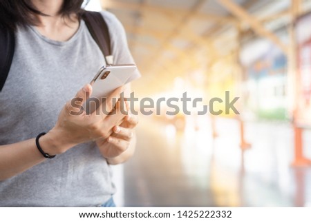 women hands holding and using cell phone contact people at outdoor.texting message chatting with friend while travelling