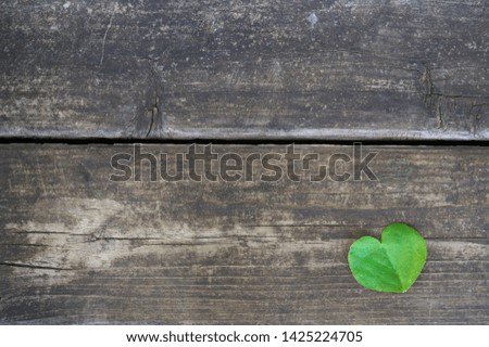 Background image with leaves in heart shape as motif