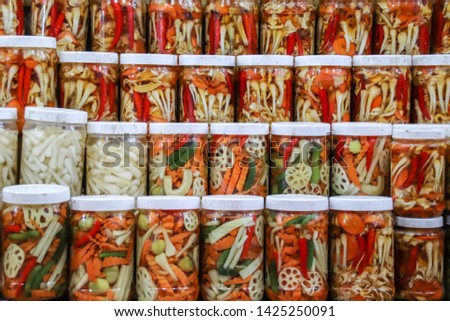 Do chua or vietnamese pickled vegetables sold in jars at the local market in Vinh long, Mekong Delta Vietnam