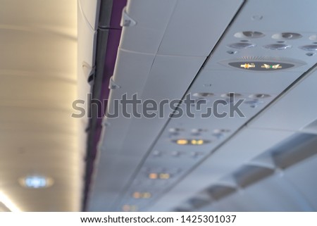 Fasten seat belt and no smoking signs in aircraft, overhead console of conditioner in a airplane. signs in the plane.
