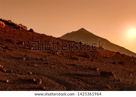 Volcano Teide, Tenerife Spain. Landscape view at sunset Surreal picture of a red desert terrain like mars surface. Mountain panorama at the golden hour with no one Tourist postcard from Canary Island