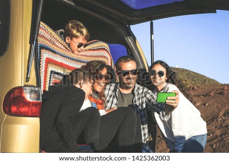 Group of smiling people taking selfie with smartphone. Family activity on weekend or holiday Happy wife and husband with kids enjoying mountain holiday together Togetherness happiness carefree concept