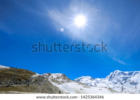 view of snow mountain landscape background and  the sun in sunny day in Switzerland