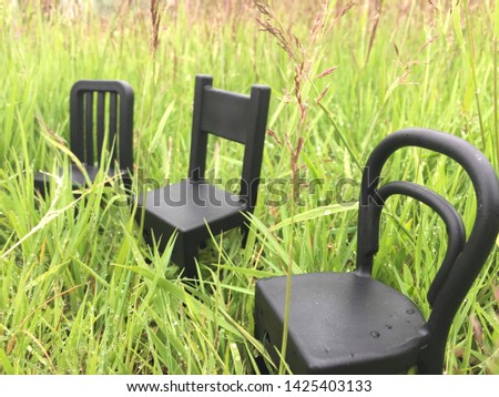 chairs on the background of grass and the city. children's furniture. background for the presentation, creative visualization of furniture and negotiations in the open air