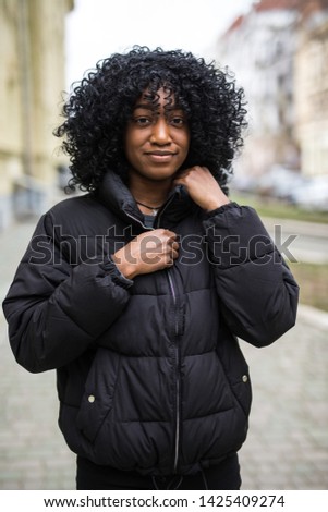 African american woman model in coat in the street