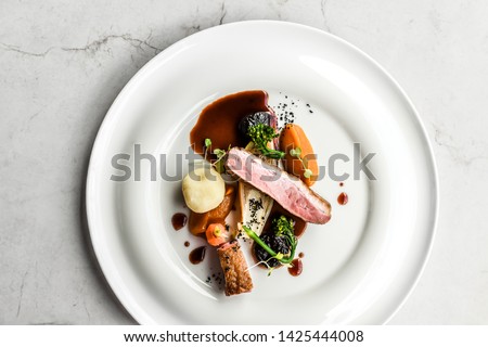 meal meat food fine cuisine beef elegant black modern restaurant table top view decoration chef gourmet dinner tasty delicious diet  Royalty-Free Stock Photo #1425444008