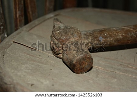 Old rusty hammer on a chair