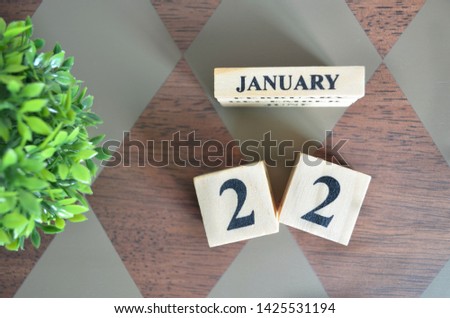 Date of February month with leaf on diamond pattern table for background.