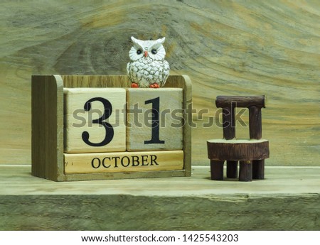 an owl sitting on block date 31 October , Halloween concept