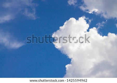 White clouds against a blue sky.