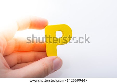 Hand holding letter cube P of made of wood