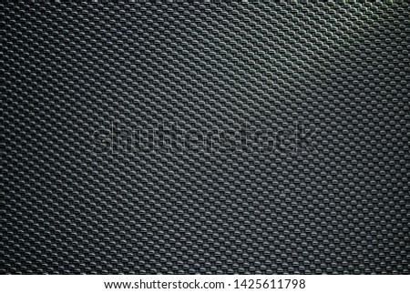 Black background with grille pattern.