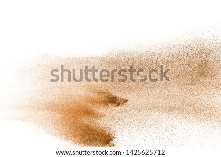 Abstract brown powder splatted on white background.
