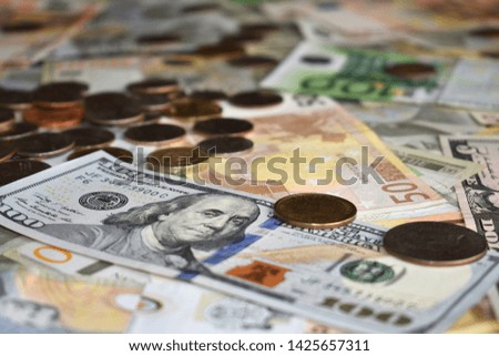coins US dollar and euro bills all over the photo