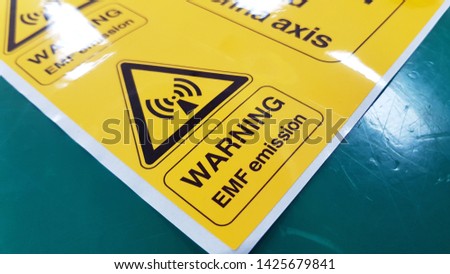 Warning EMF Symbol Sign,Radiation warning sign on the Hazardous materials transport label Class 7 at the aluminum container of transport truck Royalty-Free Stock Photo #1425679841
