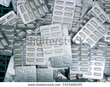 White capsules in the silver blister packs, they are put together in a basket