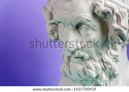 Gypsum copy of ancient statue Homer head on a blue background. Plaster sculpture man face.