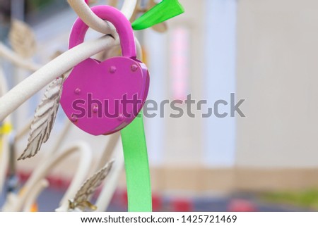 Door lock with decorations on the tree of happiness as a symbol of love on a blurred background of a light wall with copy space