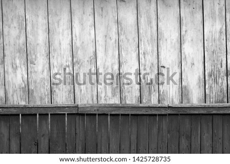 Old grunge wooden fence and wooden wall pattern in black and white. Abstract background and texture for design.
