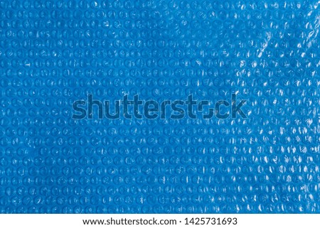 Plastic bubble film on blue background