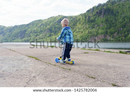 Boy skating in mountain park in Divnogorsk