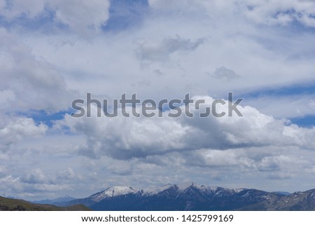 Sky with clouds over the mountains with trees.
Texture background for design