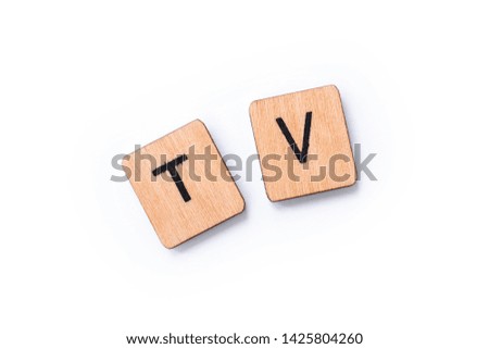 TV, the abbreviation for Television, spelt with wooden letter tiles over a white background.