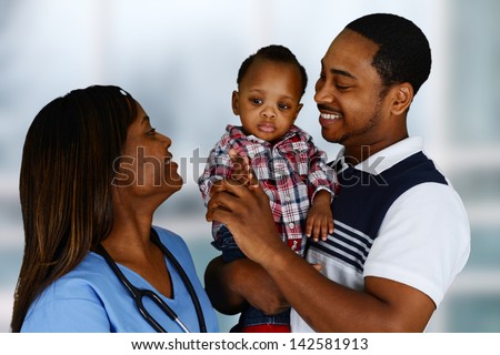 Minority nurse working at her job in a hospital with family