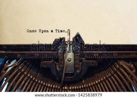 Typewriter typing out ONCE UPON A TIME Royalty-Free Stock Photo #1425838979