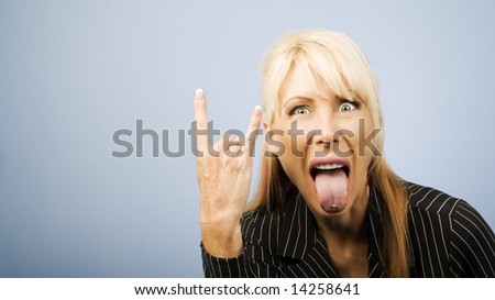 Businesswoman in a pinstripe suit making a bull horns sign