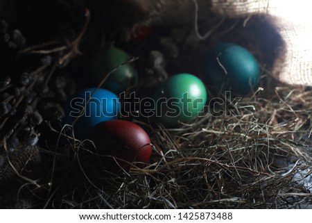 Easter painted eggs on burlap and straw
