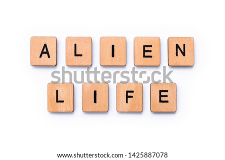 The phrase ALIEN LIFE, spelt with wooden letter tiles over a white background.