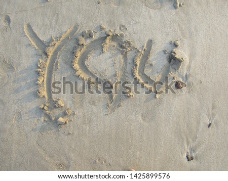 Close up view Hand writing on sand beach side with sign blank use design elemental nature. Summer spring day Form words alphabet typescript font written drawn carved note text. Spelled purpose wedding