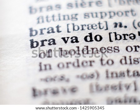 Dictionary definition of word bravado. Selective focus.
