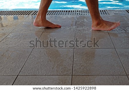 Non-slip flooring, tile flooring  Foot action The swimming pool. Royalty-Free Stock Photo #1425922898