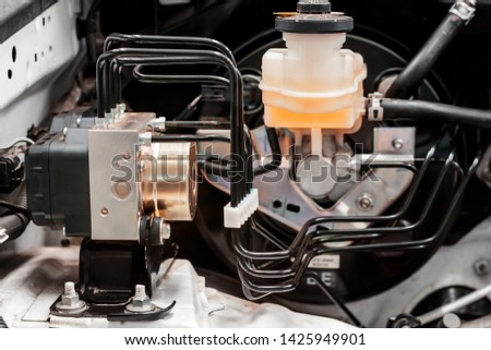 Car ABS unit module with pipes  and tank of brake fluid Brake control in the car Royalty-Free Stock Photo #1425949901