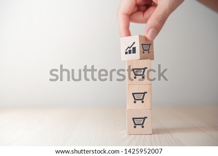 sale volume increase make business grow, Flips cube with icon graph and shopping cart symbol. Royalty-Free Stock Photo #1425952007