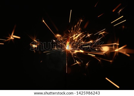 New year sparkler candle isolated on black background. Bengal fire. 