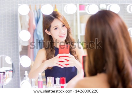 beauty asian woman makeup and take selfie in the mirror